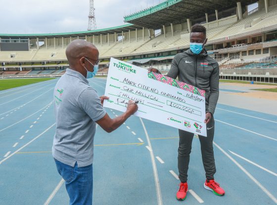 Mark Otieno (R) with Safaricom CEO Peter Ndegwa after the telco unveiled a Ksh1 million sponsorship for the sprinter as he prepares for the Olympic games to be held in Tokyo, Japan.